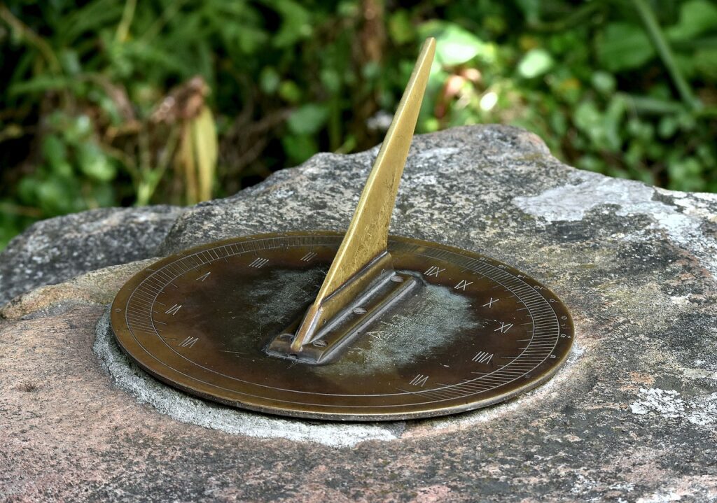 garden sundial mounted to a rock
